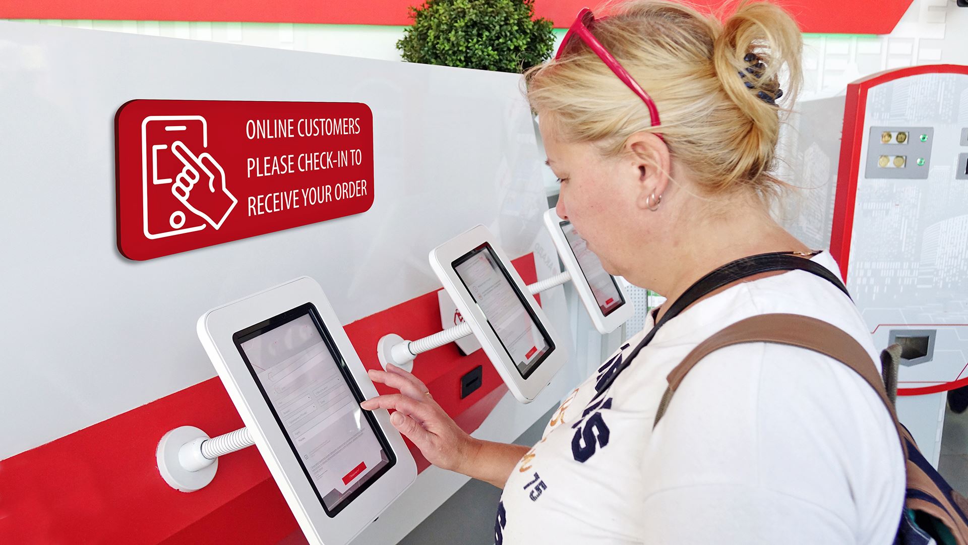 woman at a digital kiosk